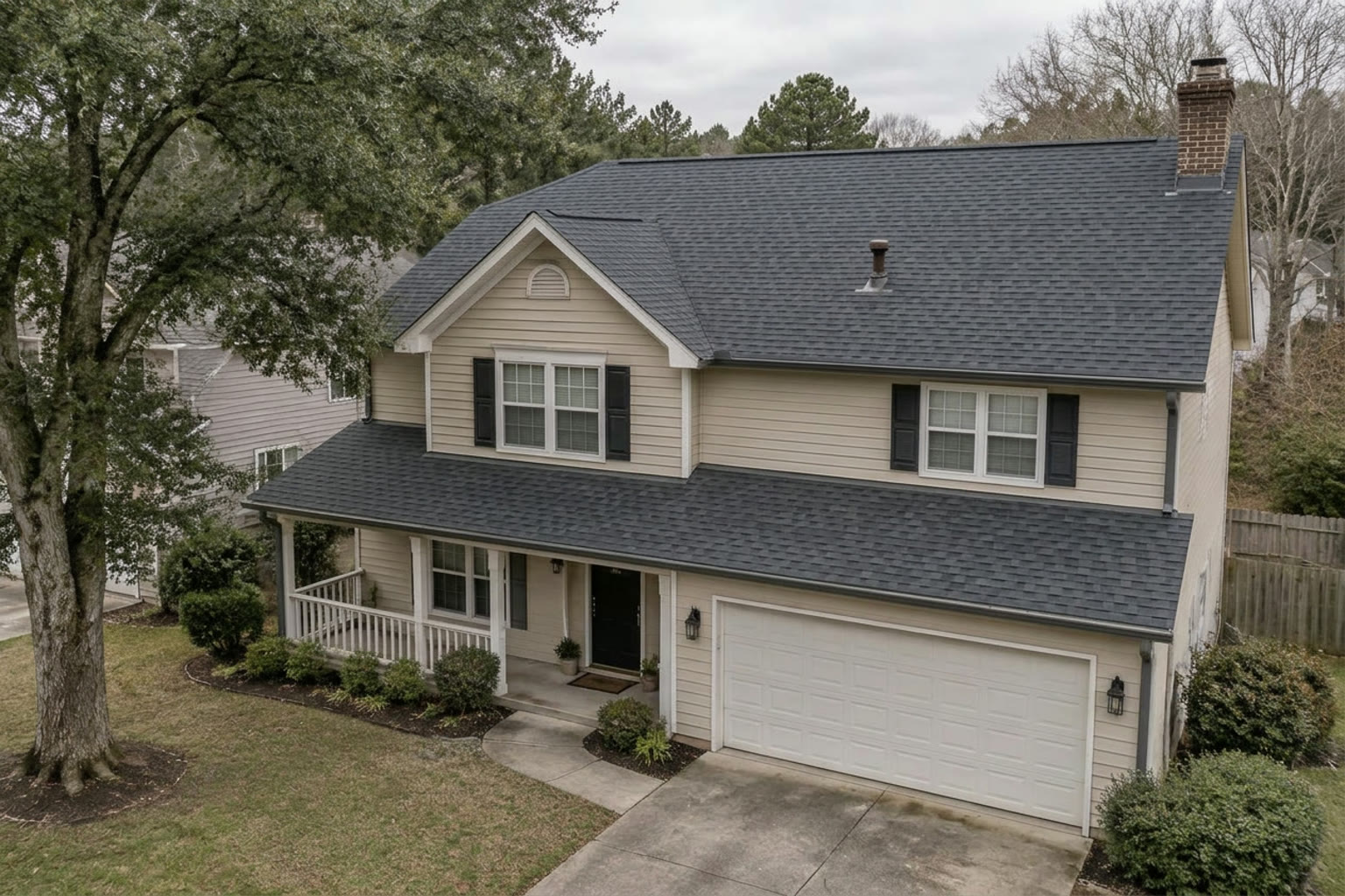 The same home with a new charcoal architectural shingle roof
